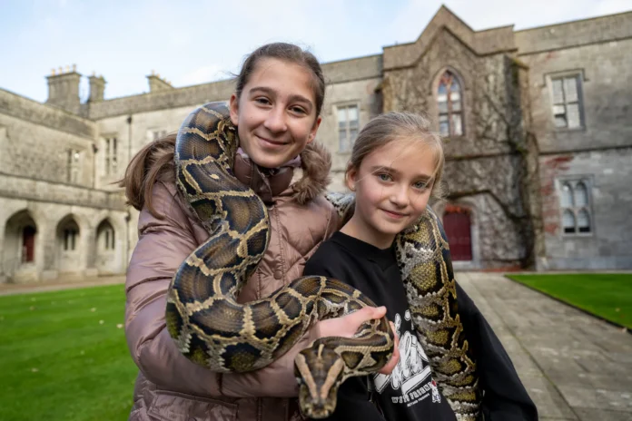 Sisters Victoria 11 and Gabby Wujanisz 8 with 10 Foot python